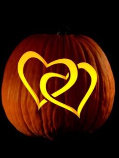 a pumpkin with two hearts carved into it