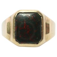 Vintage from the 1960s Size: 9 1/2 US Materials: Gold Gemstone: Bloodstone Gem color: Black Band color: Gold This is a super unique ring. Mens Bloodstone signet ring. Condition: Shows minimal signs of wear. Has not been polished. Details: 10k Yellow Gold 5.5grams total Marked 10k 10mm by 12mm Rectangle Bloodstone 5mm rise Bloodstone Ring, Tigers Eye Gem, Mens Band Rings, Blood Stone, Signet Ring Men, Carved Ring, Red Blood, Ring Mens, Gold Signet Ring