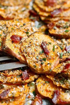 a close up of food on a pan with a spatula in the foreground