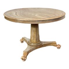 a round wooden table with carved legs on an isolated white background for use as a centerpiece