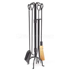 a metal rack with two brooms and a brush in it on a white background