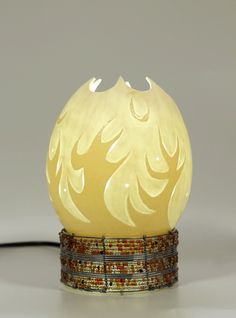 an egg shaped lamp sitting on top of a table