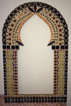 an arch made out of various colored tiles