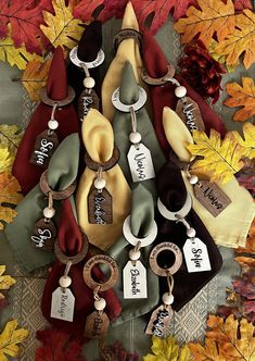 an assortment of personalized items are displayed on a table with autumn leaves around them