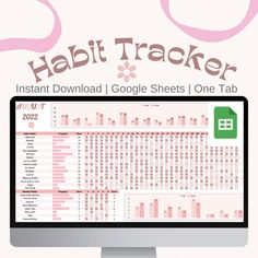 a computer monitor sitting on top of a desk with the words habit tracker above it