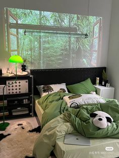 a bed room with a neatly made bed and a green comforter on top of it