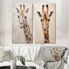 two giraffes standing next to each other in a living room with white walls