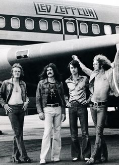 a group of people standing in front of an airplane