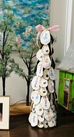 a christmas tree made out of plates sitting on a table next to a framed photo