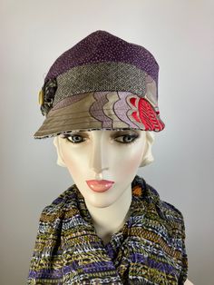 This pretty purple, beige, red and black baseball style multi fabric newsboy cap is a standout! It is made with lovely sample fabrics that would have been destroyed but instead was made into a functional and pretty accessory. It is topped with a rosette and vintage mother of pearl button. The hat is fully lined with a pretty cotton fabric and an inner grosgrain ribbon helps the hat keep its shape and keep it free from makeup. This baseball/newsboy shape is deeper than a traditional baseball hat and sits lower on the head - looks best with your ears tucked under. Wear the brim down in the traditional manner or flip it back for an additional look. A great hat for travel as well. In stock and ready to ship. ++++++++++++++++++++++++++FIT AND SIZE: Comfortably fits a 21 1/2 to 22 1/2 inch head Purple Winter Hat With Curved Brim, Purple Beanie For Fall, Purple Short Brim Winter Hat, One Size Fall Cap Mini Hat, One Size Fall Mini Cap Hat, One Size Purple Cap, Purple One Size Cap, Winter Baseball Cap With Short Brim, Fall Baseball Cap With Short Brim