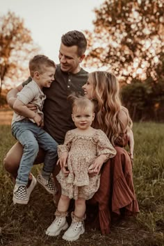 a man and two children are posing for a family photo