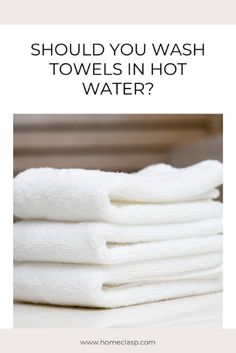 towels stacked on top of each other with the words should you wash towels in hot water?