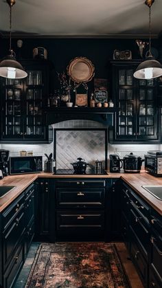 a kitchen with black cabinets and wooden counter tops, along with an area rug on the floor