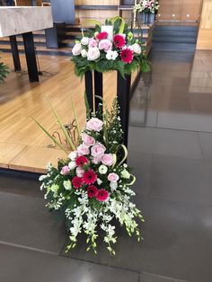 a floral arrangement is placed on the ground