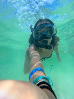 a person swimming in the water with snorkels on their head and goggles on