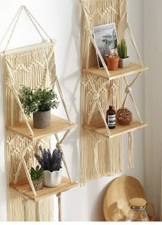 two macrame style shelves with plants and books on them, hanging from the wall