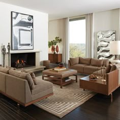 a living room filled with furniture and a fire place under a painting on the wall