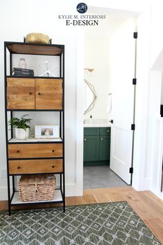 a shelf with drawers and baskets on it in the corner of a room next to a door