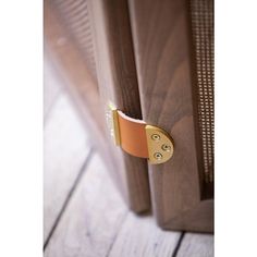 a close up of a wooden door with a metal handle on the front and side