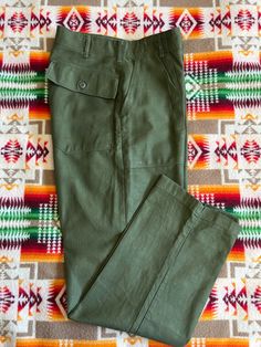 Vintage pair of Vietnam era OG 107 cotton sateen Utility pants aka Baker Pants. DSA number indicates a manufacture date of 1968. In very good vintage condition All buttons intact. Zipper fly, Rapid Zipper. it's getting harder to find these, especially in such great condition. Size marked 32x31  but please refer to the Actual measurements: lying flat, the waist measures 15 inches across the measured lying flat, rise is 13 inches inseam is 30 1/4  inches and overall length is 42 1/4 inches and the leg opening is 9 inches measured flat. Please review all photos, descriptions and measurements. Feel free to ask questions. All sales final. Retro Cotton Cargo Pants With Pockets, Flat Front Cotton Work Pants With Pockets, Fitted Cotton Work Pants With Patch Pockets, Retro Cotton Pants With Belt Loops, Retro Cotton Straight Leg Work Pants, Retro Cotton Straight Leg Cargo Pants, Retro Straight Leg Cotton Work Pants, Retro Straight Leg Cotton Cargo Pants, Retro Cotton Cargo Pants