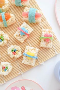 rice krispy kreme treats are on a bamboo mat next to a plate