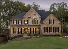 a large brick house with lots of windows