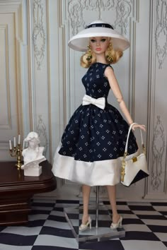 a doll wearing a dress and hat holding a purse