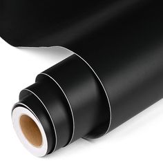 a roll of black paper on a white background