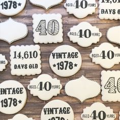 decorated cookies are displayed on a table for the forty years anniversary celebration in black and white