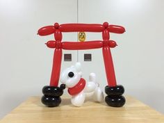 an inflatable balloon dog sitting on top of a wooden table