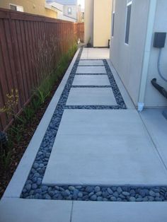 an outdoor walkway is shown in front of a fence