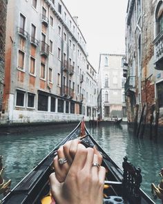 a person's hand on the handle of a gondola in venice, italy