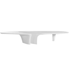 an oval white table with curved legs on a white background, viewed from the side