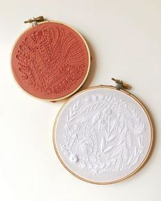 two embroidery hoops sitting next to each other