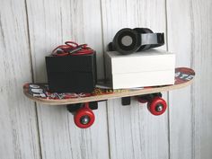 a skateboard is mounted to the side of a wall with some items on it