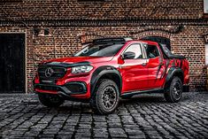 a red truck parked in front of a brick building