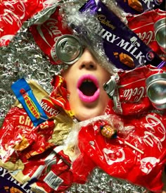 a child in tin foil with candy and soda cans