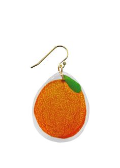 an orange earrings with a green leaf hanging from it