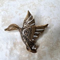 This vintage brass duck brooch pin pendant is a unique addition to any jewelry collection. Crafted in Spain, it features a beautifully detailed shape of a duck with a brown color and a length of 1 7/8 inches. The brooch is signed and made of brass, adding to its durability and quality. Perfect for any occasion, whether it's Mother's Day, Christmas, Graduation, Father's Day, or Birthday, this brooch will make a great gift for someone special. Its retro style and nature and bird theme make it a great conversation piece. Add this one-of-a-kind item to your collection today! Same or next day shipping Bird Theme, A Duck, Pin Pendant, Retro Stil, Conversation Piece, Style Retro, Vintage Brass, Retro Style, Brown Color