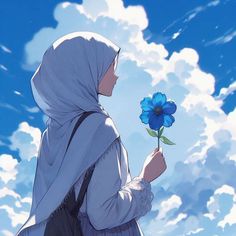 a woman holding a blue flower in her hand and looking up at the sky with clouds behind her