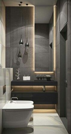 a bathroom with a bathtub, sink and lights hanging from the ceiling above it