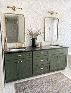 a bathroom with two sinks, mirrors and a rug on the floor in front of it