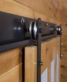 a close up of a wooden door with metal handles