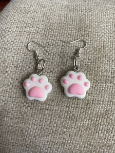 These adorable polymer paw earrings are perfect for that cat or dog lover in your life! These are small sized earrings and are finished with ear wire to fit perfectly into your earlobes! Show your love for your pets with these earrings! This would be a great birthday present, anniversary present, Valentine's Day  present, or graduation gift. The sleek design of this pendant will turn heads and make you take a second look! Like what you see? View more at: https://www.etsy.com/shop/StephsCraftingBits Cute Hypoallergenic Cat Ears Jewelry, Cute Cat Design Dangle Earrings, Hypoallergenic Cat Ears Jewelry For Gift, Cute Cat Design Dangle Jewelry, Kawaii Cat Ears Jewelry For Gift, Pink Cat Ears Jewelry As A Gift, Pink Cat Ears Jewelry As Gift, Cute White Cat Ears Jewelry, White Cat Design Earrings As A Gift