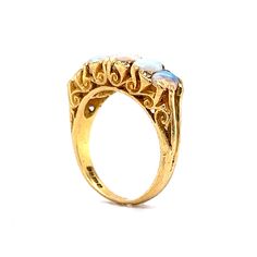 This antique Victorian era ring boasts an antique feel that will transport you to a time of glamour and luxury. Crafted from 18 karat yellow gold, this ring features beautiful cabochon opals as the primary stones and are set across the entirety of the band. The opals are complemented by eight diamonds, adding a hint of sparkle. Its timeless beauty and exceptional quality make it the perfect addition to any jewelry collection. Whether you're looking for a statement piece for a special occasion or Metal Shop, Shop Engagement Rings, Opal Ring, Opal Rings, Antique Victorian, Victorian Era, Shop Earrings, Timeless Pieces, Shop Necklaces