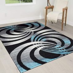 a black and blue area rug in a living room with a chair next to it