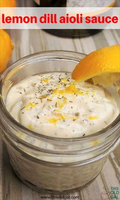 lemon dill aioli sauce in a glass jar with an orange peel on top