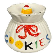 a ceramic vase with the word cake painted on it's side and an orange bow