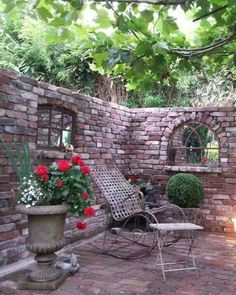 an outdoor patio with brick walls and potted plants