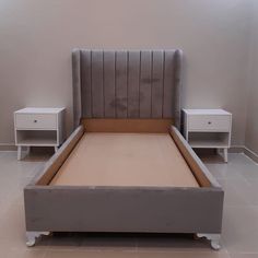 a bed with two nightstands next to it in a room that has white tile flooring